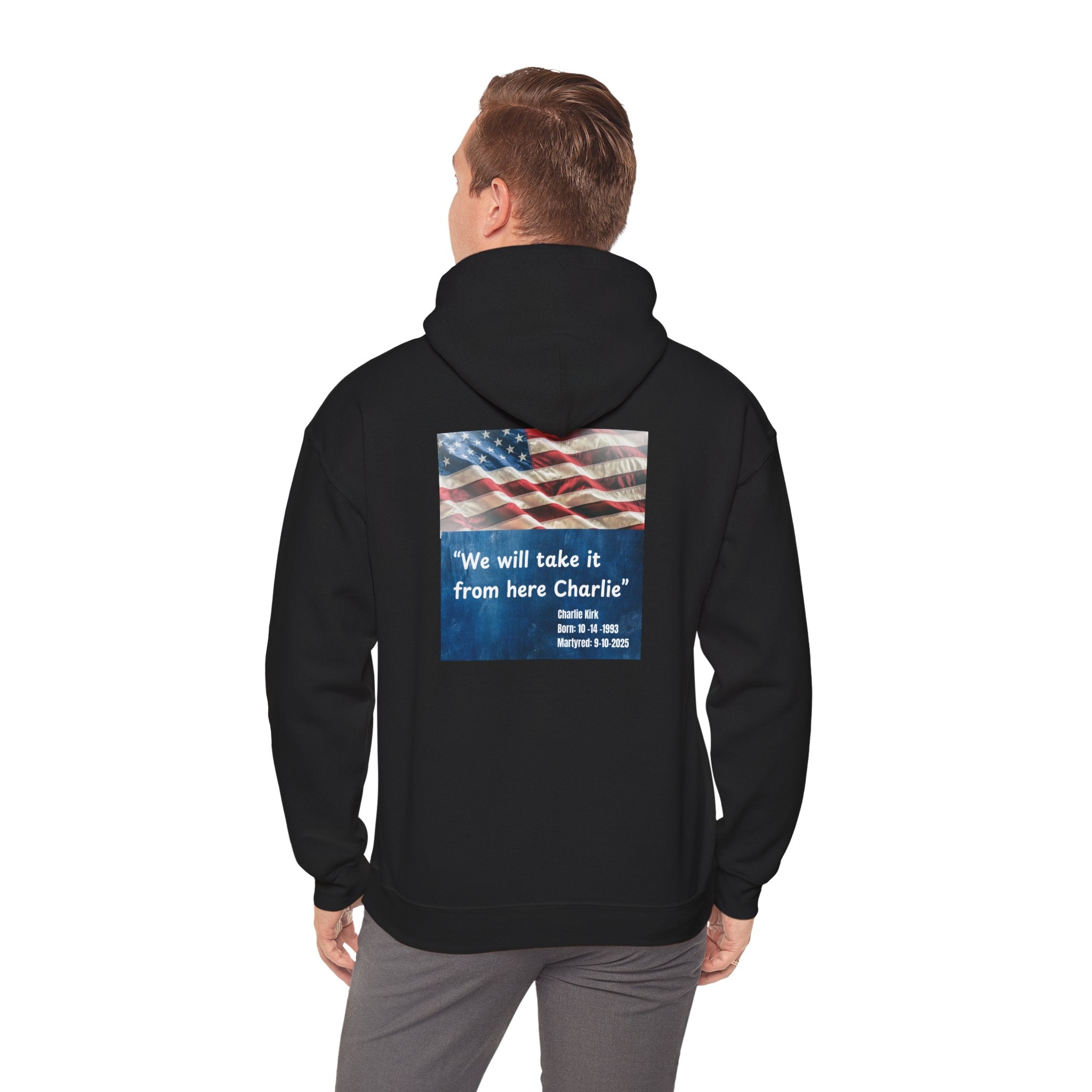 Person wearing a black hoodie with an American flag and text on the back, on a white background